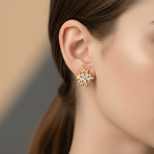 Five-Petal Gold Stud Earrings worn by a person with a blurred background
