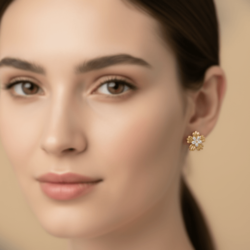 Close-up of a woman wearing Five-Petal Gold Stud Earrings with a neutral background