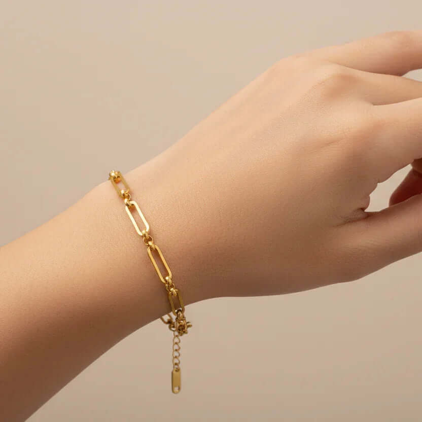 Ceyrah gold paperclip chain bracelet on wrist, minimalist jewellery style