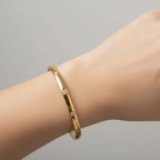 Ceyrah gold square zircon bangle bracelet on wrist, minimalist jewellery style