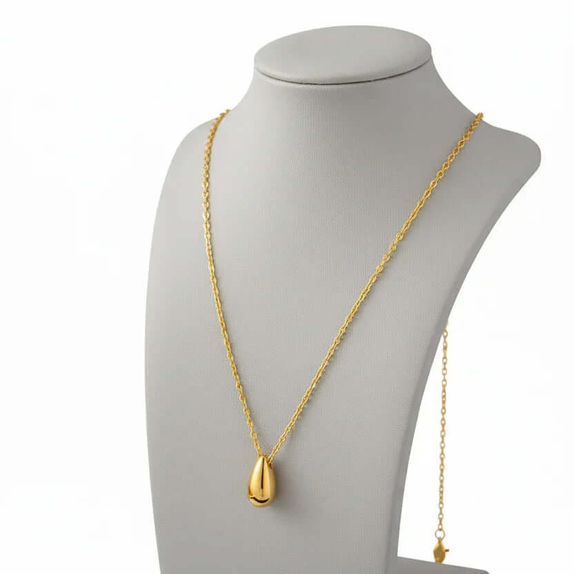 Ceyrah gold teardrop pendant necklace on display bust, elegant jewelry accessory