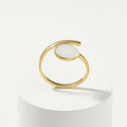 Gold Teardrop Wrap Ring featuring a smooth white teardrop center and a polished gold-tone frame.