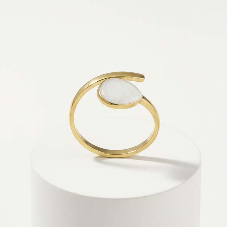 Gold Teardrop Wrap Ring featuring a smooth white teardrop center and a polished gold-tone frame.