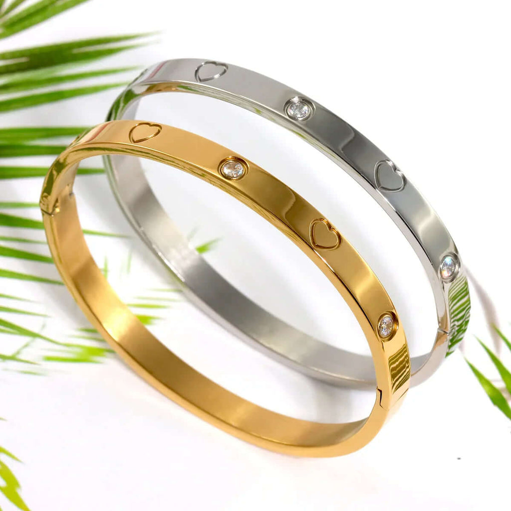 Ceyrah gold and silver heart engraved bangle bracelet on white background