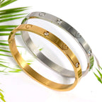 Ceyrah gold and silver heart engraved bangle bracelet on white background