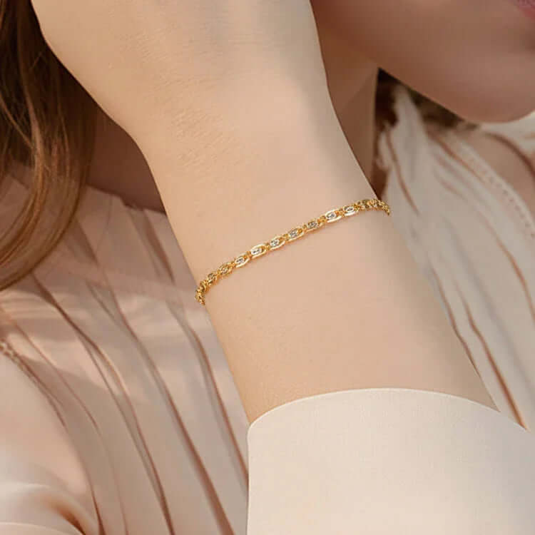 Elegant gold oval link bracelet on woman's wrist, Ceyrah jewelry accessory