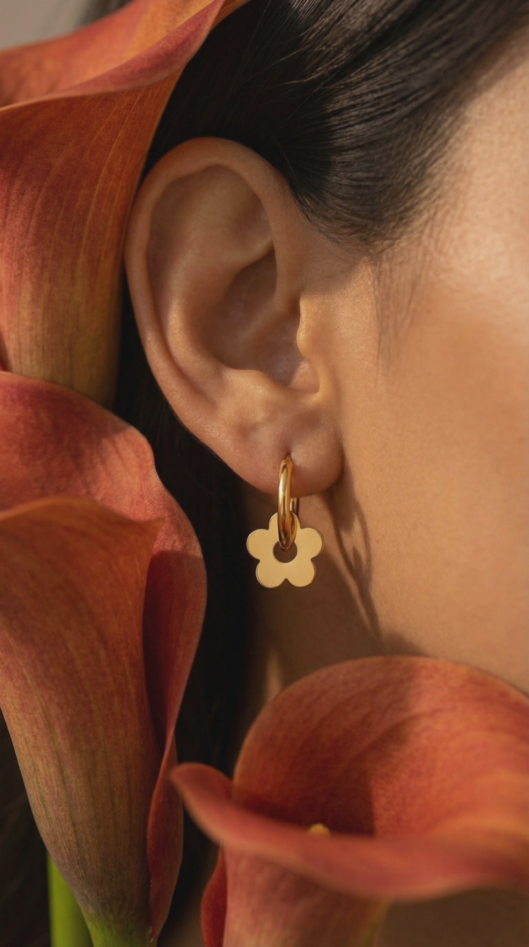 Ceyrah gold hoop earrings with flower-shaped charms
